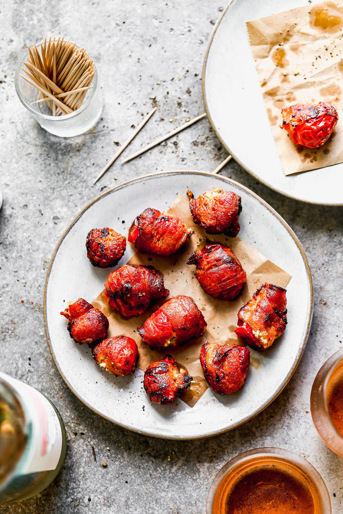 If you grabbed a dictionary and looked up the definition for amuse bouche, there would surely be a photo of our Bacon-Wrapped Stuffed Peppadews  next to the word